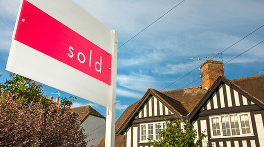 A house with a sold sign in the front garden